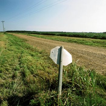 Bent stop sign on gravel road, Mississippi Delta