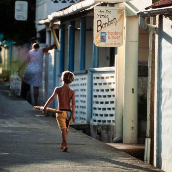 Young boy carrying french bread, Isles des Saintes, French West Indies, Caribbean
