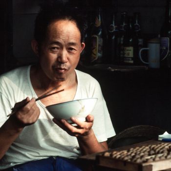 Man eating with chopsticks, Guangzchou (Canton), China