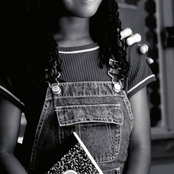 Portrait of African American school girl with notebook. Century Tel. Louisiana