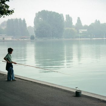 Young boy fishing, Lake Annency, France