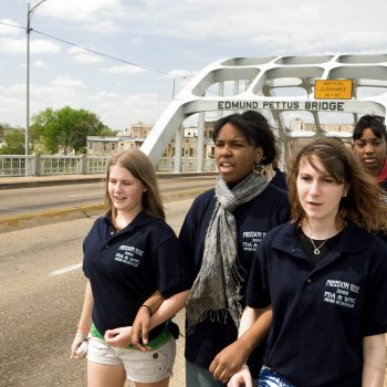 Racially mixed group of students walking across Edmund Pettus Bridge, Selma, AL