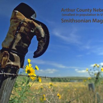 Old cowboy boot on fence pointing to cemetery, Arthur County, Nebraska