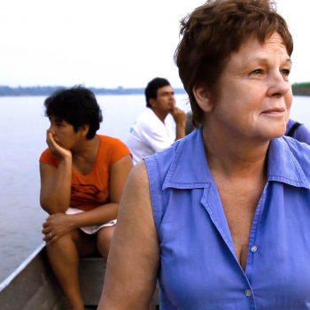 Gina Low of APECA on boat on Amazon River, Peru. Opening Our Eyes Movie.