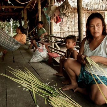 Woman in hut weaving. Amazonian village, Peru. Opening Our Eyes Movie.