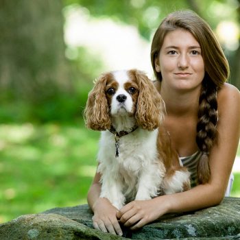 Portrait of young girl and dog.
